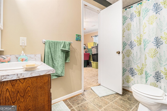 bathroom with vanity, ornamental molding, and toilet