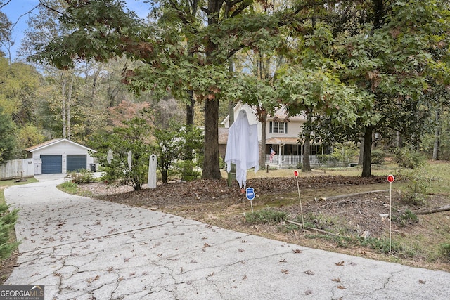 view of front facade with a porch, a garage, and an outdoor structure