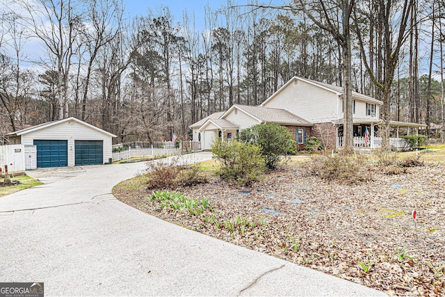 view of side of property featuring an outbuilding, a garage, and a porch