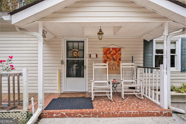 view of exterior entry with covered porch