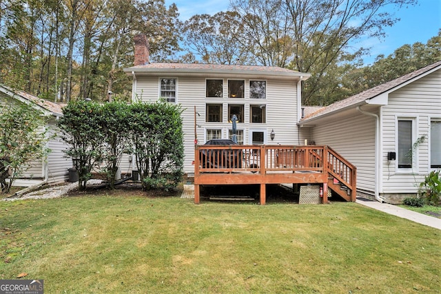 back of property featuring a yard and a deck