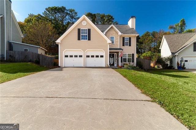 view of front of home with a garage and a front lawn