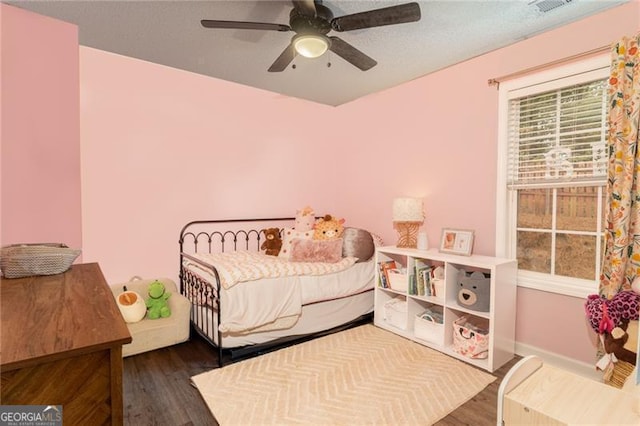 bedroom featuring ceiling fan and dark wood-type flooring