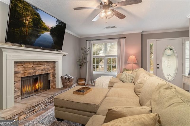 living room with hardwood / wood-style flooring, a fireplace, ceiling fan, and crown molding