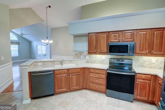 kitchen with sink, hanging light fixtures, ceiling fan with notable chandelier, kitchen peninsula, and stainless steel appliances