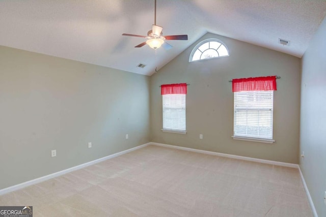 spare room with light carpet, ceiling fan, and lofted ceiling