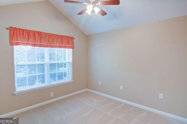 carpeted spare room featuring ceiling fan and vaulted ceiling