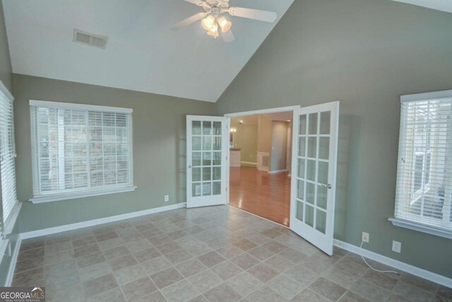 empty room featuring a wealth of natural light, french doors, high vaulted ceiling, and ceiling fan