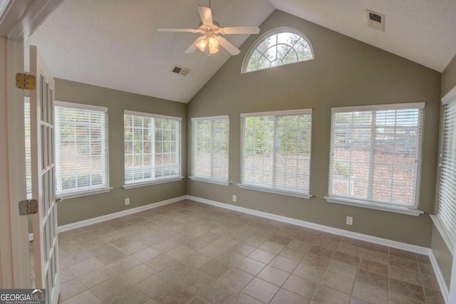 unfurnished sunroom with vaulted ceiling and ceiling fan