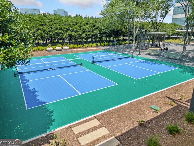 view of tennis court featuring basketball hoop