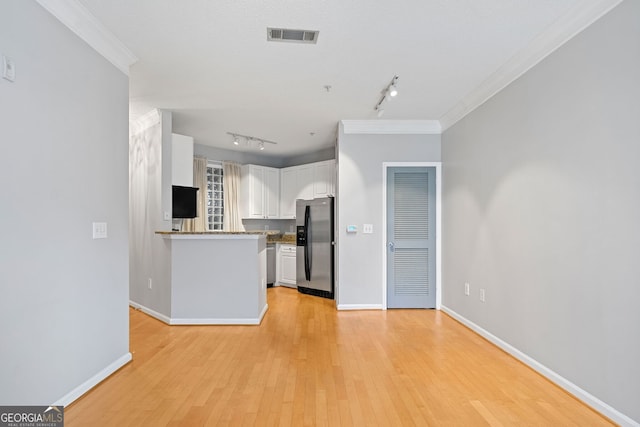 kitchen with rail lighting, stainless steel fridge with ice dispenser, light hardwood / wood-style floors, white cabinets, and ornamental molding