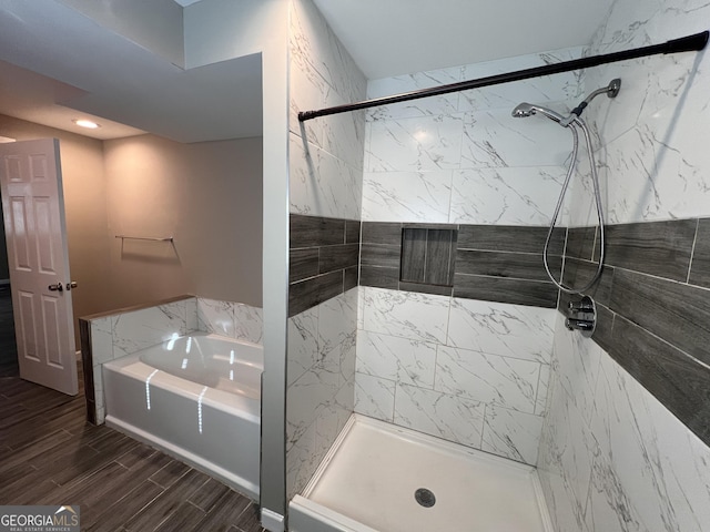 bathroom featuring tile walls and independent shower and bath