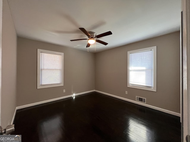 spare room with ceiling fan, plenty of natural light, and hardwood / wood-style floors