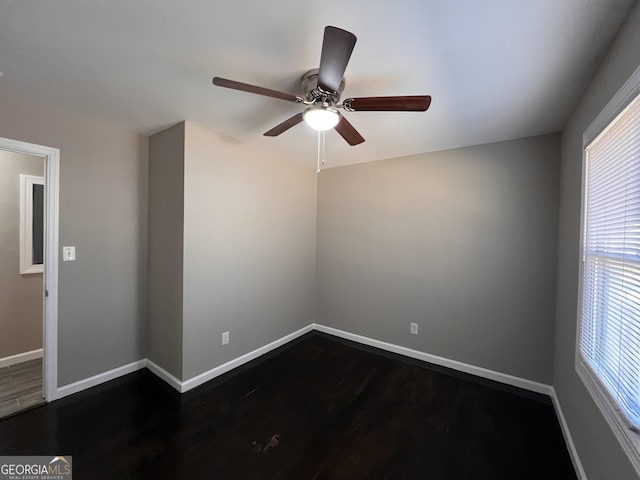 unfurnished room featuring ceiling fan and dark wood-type flooring