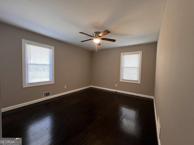 unfurnished room featuring ceiling fan and dark wood-type flooring