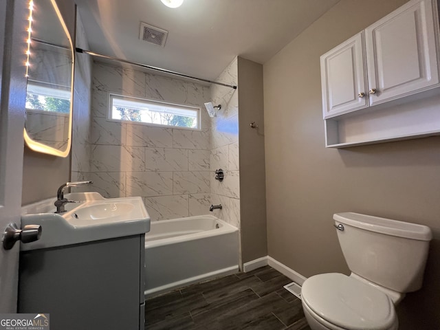 full bathroom with vanity, toilet, and tiled shower / bath