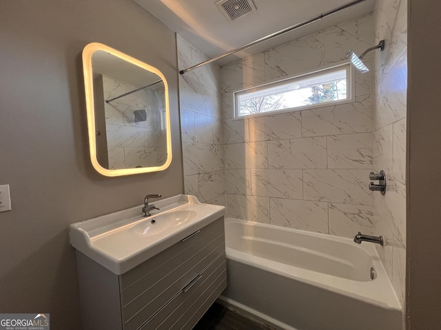 bathroom featuring vanity and tiled shower / bath combo