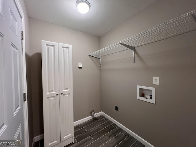 washroom with electric dryer hookup, dark hardwood / wood-style flooring, and hookup for a washing machine