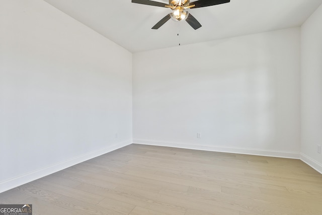 empty room with ceiling fan and light hardwood / wood-style floors