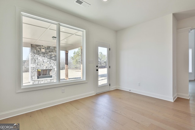 interior space featuring a fireplace and light hardwood / wood-style flooring