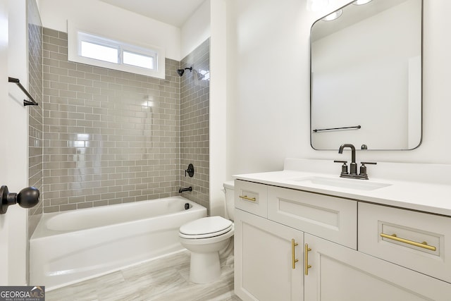 full bathroom with vanity, toilet, and tiled shower / bath