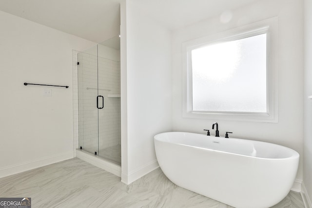 bathroom featuring shower with separate bathtub