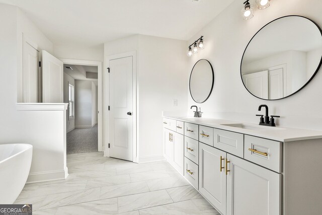 bathroom with vanity and a washtub