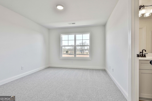 unfurnished room featuring light carpet