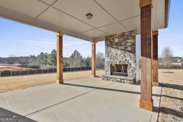 view of patio with an outdoor stone fireplace