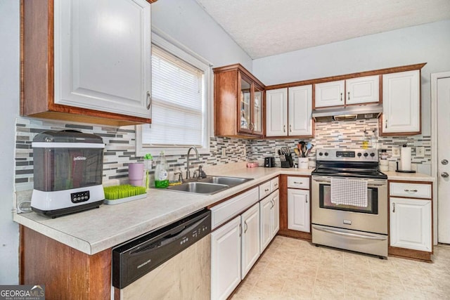 kitchen featuring decorative backsplash, sink, white cabinets, and appliances with stainless steel finishes