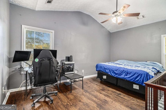 bedroom featuring a textured ceiling, ceiling fan, dark hardwood / wood-style flooring, and lofted ceiling