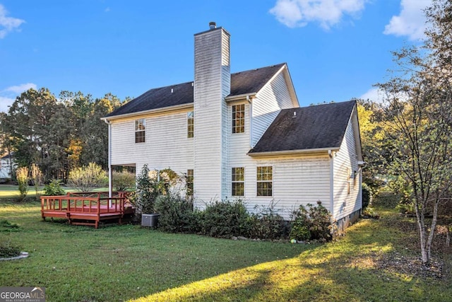 rear view of house featuring a lawn, a wooden deck, and cooling unit