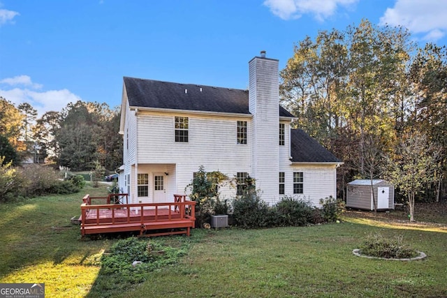 rear view of property with central AC, a lawn, a storage shed, and a wooden deck