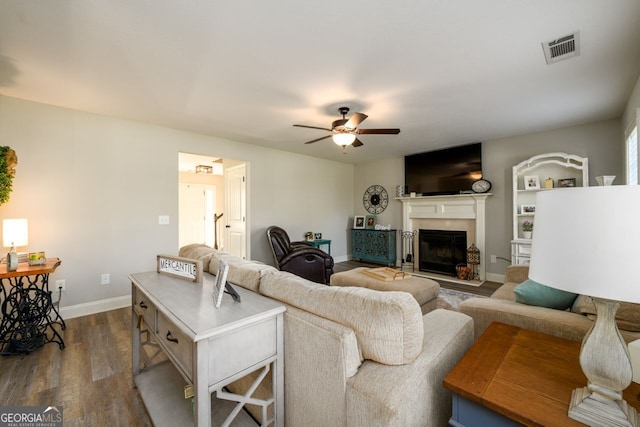 living room featuring hardwood / wood-style flooring and ceiling fan