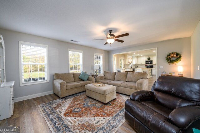 living room featuring hardwood / wood-style flooring and ceiling fan