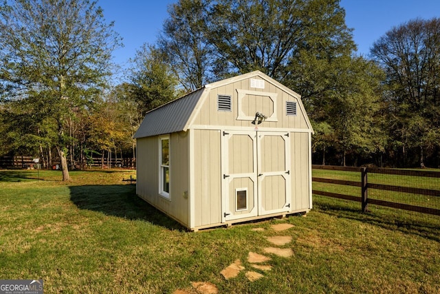 view of outdoor structure featuring a lawn