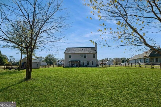 rear view of property with a lawn