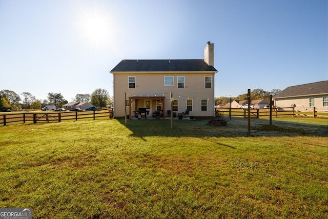 rear view of property with a yard