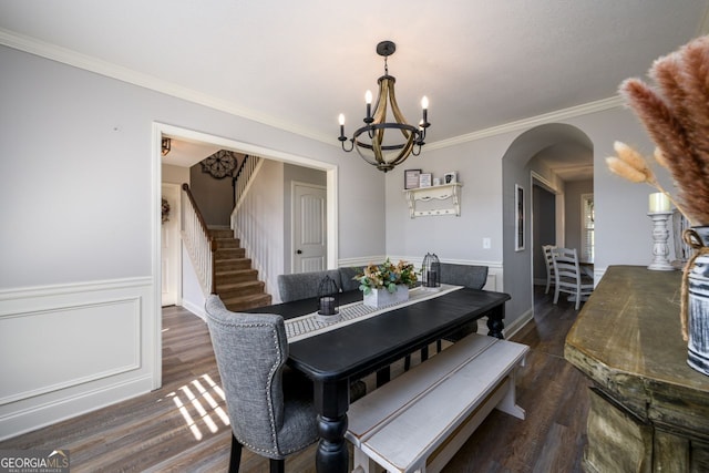 dining space with a notable chandelier, dark hardwood / wood-style floors, and ornamental molding