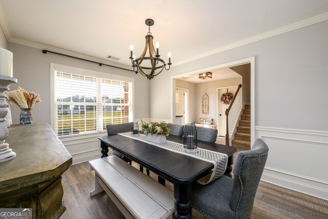 dining room with crown molding, dark hardwood / wood-style floors, and a notable chandelier