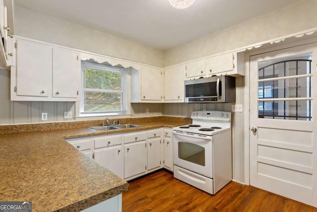 kitchen featuring electric range, sink, white cabinets, and dark wood-type flooring