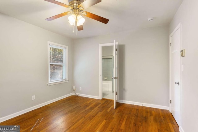 unfurnished bedroom featuring ceiling fan and dark hardwood / wood-style flooring