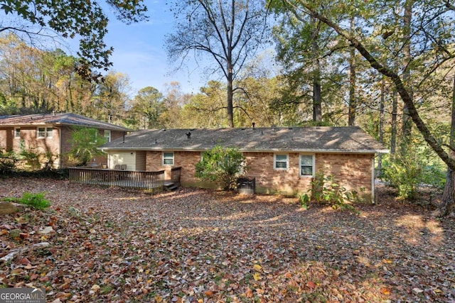 rear view of property with a wooden deck