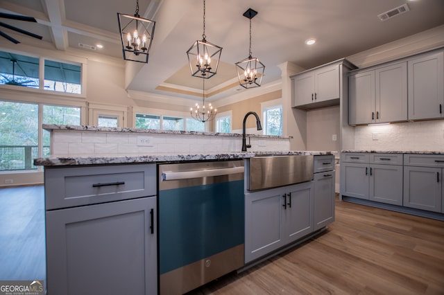 kitchen with dishwasher, gray cabinets, backsplash, and pendant lighting