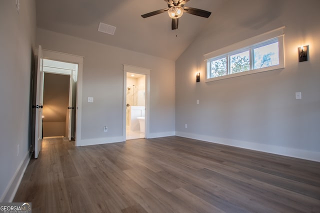 unfurnished bedroom featuring ensuite bathroom, high vaulted ceiling, ceiling fan, and dark wood-type flooring