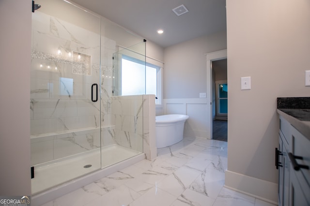 bathroom featuring vanity and plus walk in shower