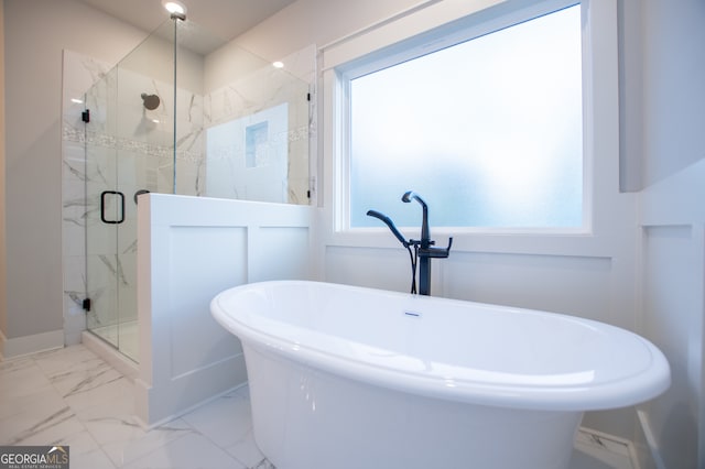 bathroom featuring independent shower and bath