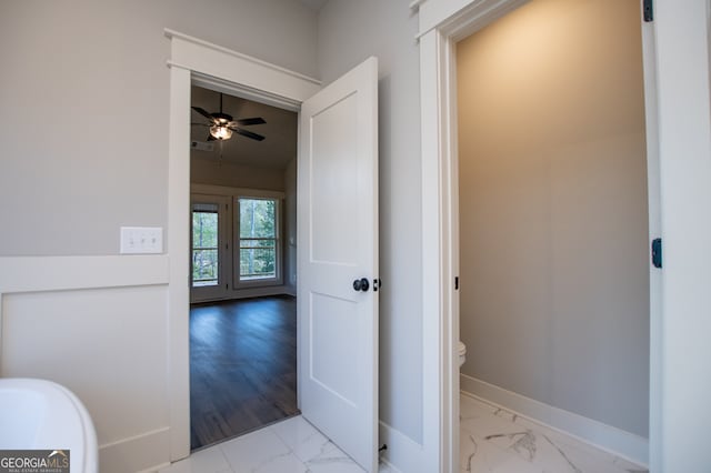 bathroom with ceiling fan, toilet, and hardwood / wood-style flooring