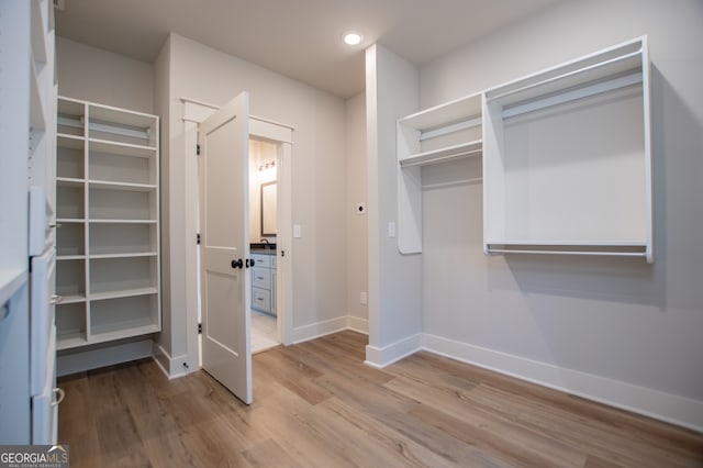 walk in closet featuring light hardwood / wood-style floors