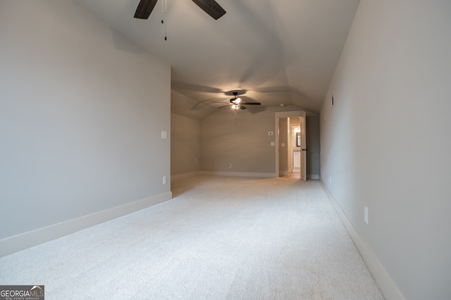 carpeted spare room featuring ceiling fan and lofted ceiling